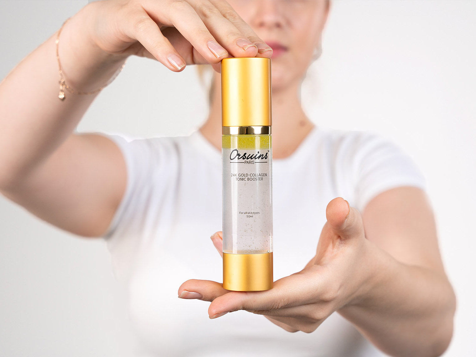 Orsuins Skin Care Model with Collagen Tonic Booster in hands